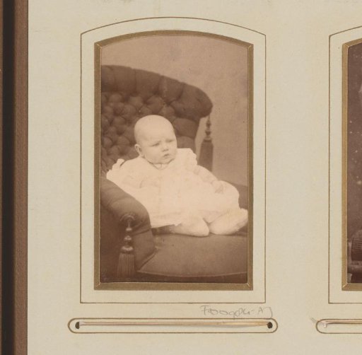 Portrait of a baby, seated in an armchair