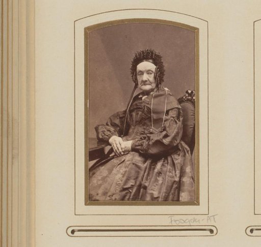 Portrait of a seated elderly woman with ringlets and a cap