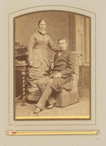 Portrait of a standing woman and a seated man