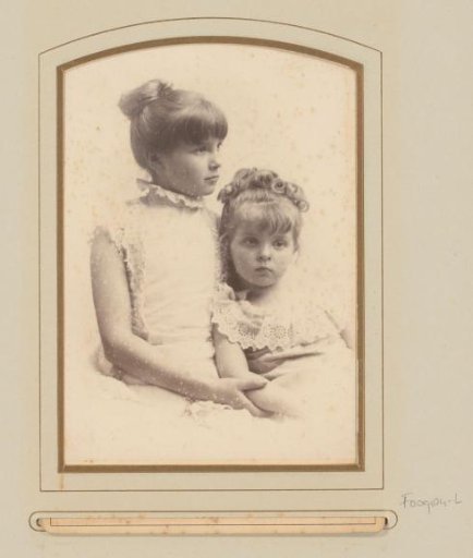 Portrait of two girls in white lace dresses