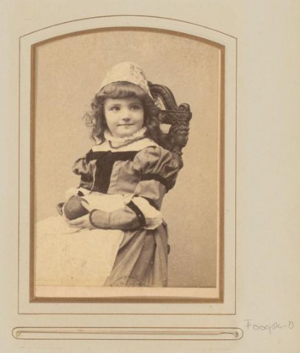 Portrait of a seated girl in costume with a ball in her hand