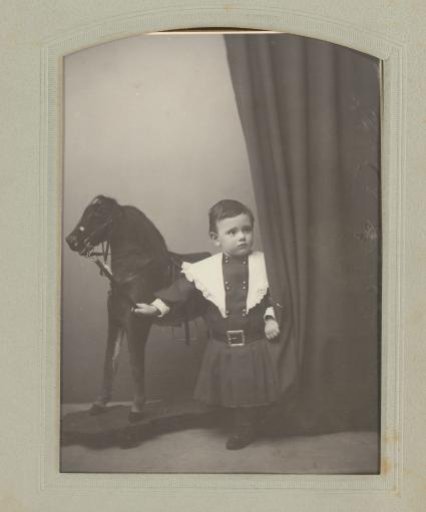 Portrait of an unknown child with a hobby horse