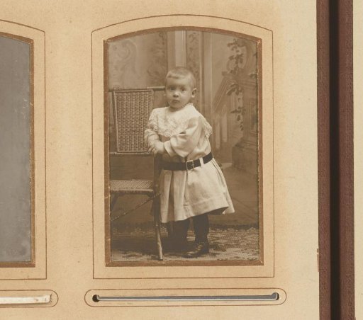 Portrait of a Child Standing by a Chair