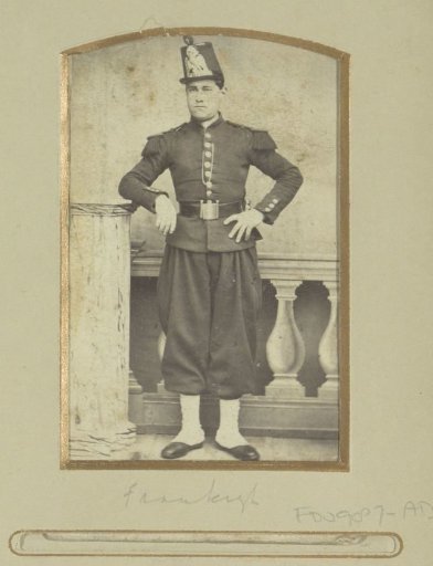 Portrait of a (presumably) French soldier, standing in breeches with a cap