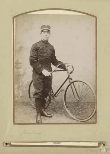 Portrait of a (presumably) Dutch soldier, standing by a bicycle