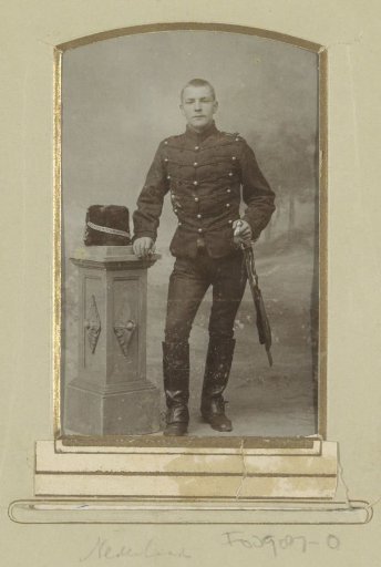Portrait of a (presumably) Dutch military man, standing by a fur cap on a pedestal