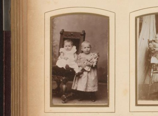 Portrait of two children, one of whom with a doll