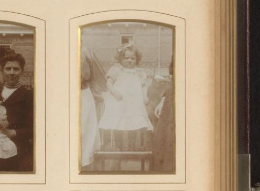 Portrait of a girl, standing on a chair in a garden