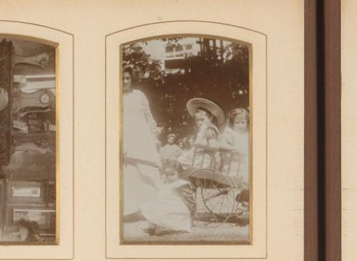 Woman and three girls with a cart in a garden