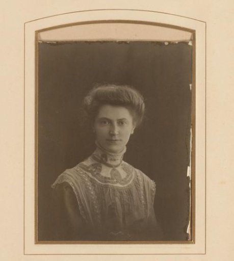Portrait of a woman in a dress trimmed with ribbon and tulle