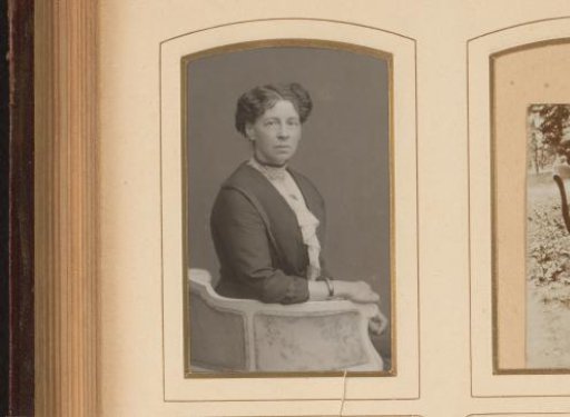 Portrait of a seated woman in a blouse with tulle