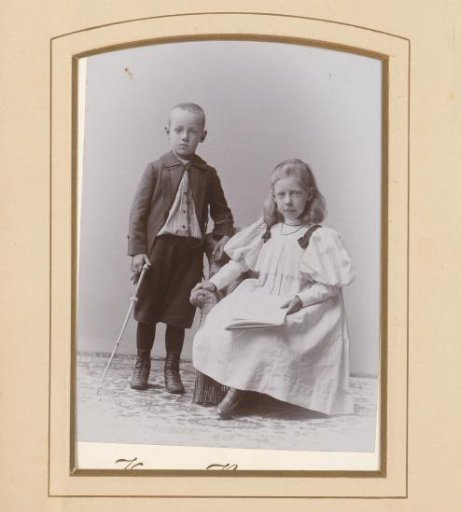 Portrait of a seated girl with a writing tablet in her hand and a standing boy with a staff