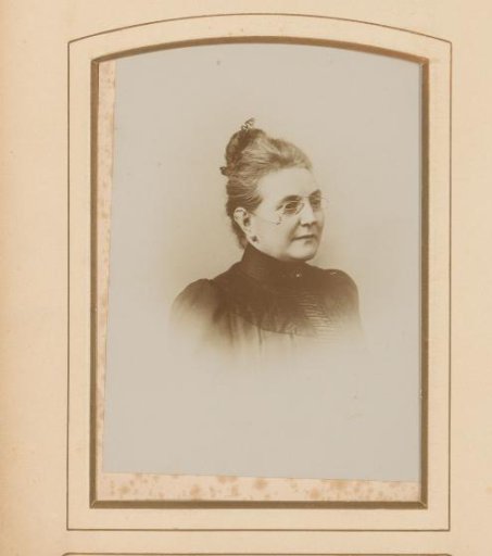 Portrait of a woman with her hair up and spectacles