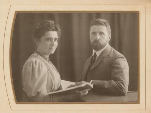 Portrait of a man and woman, each with an open book