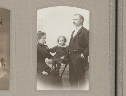 Portrait of a seated woman, a seated child and a standing man
