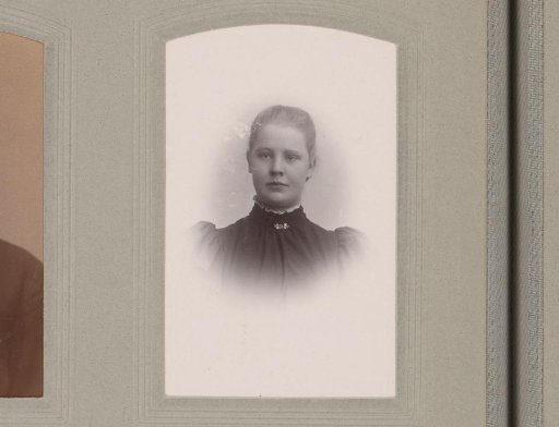 Portrait of a young woman in a high-collared dress with a jewel