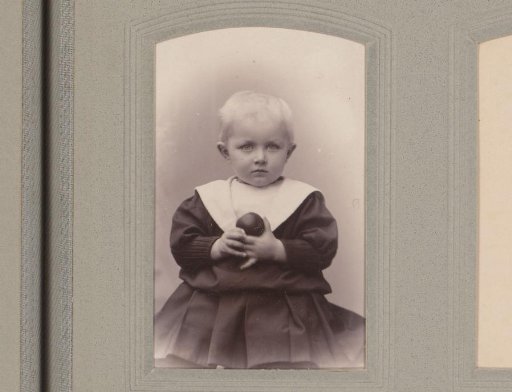 Portrait of a child with a ball in hand