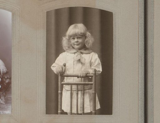 Portrait of a girl standing behind a chair