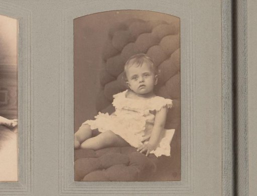 Portrait of a sitting girl in a white dress