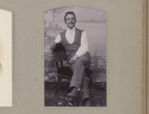 Portrait of a seated man with a cigar in his mouth