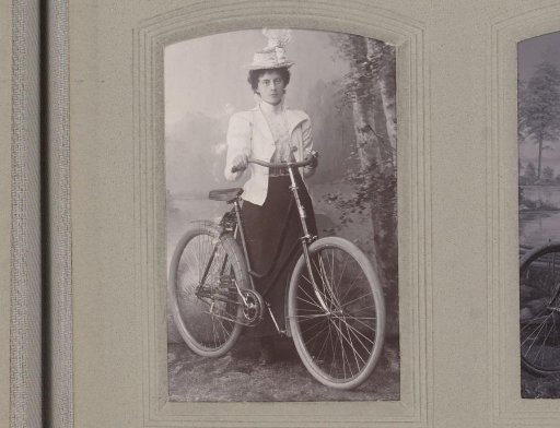 Portrait of a woman with a hat and bicycle in hand