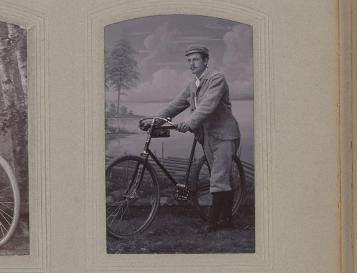 Portrait of a man with a bicycle before a backdrop