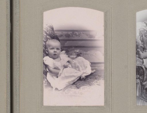 Portrait of a Seated Baby in a White Dress