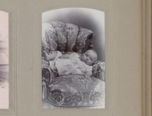 Portrait of a Baby Lying in a Chair