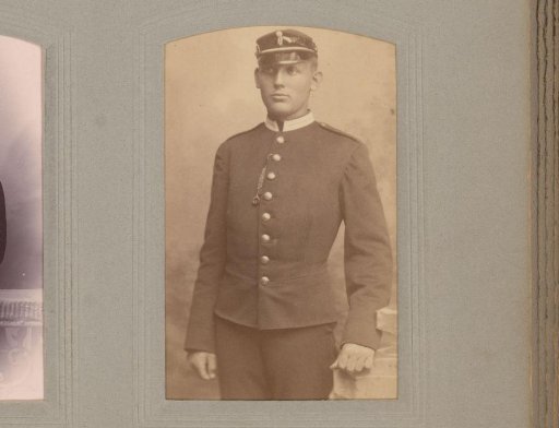Portrait of a Standing Man in Uniform with a Cap
