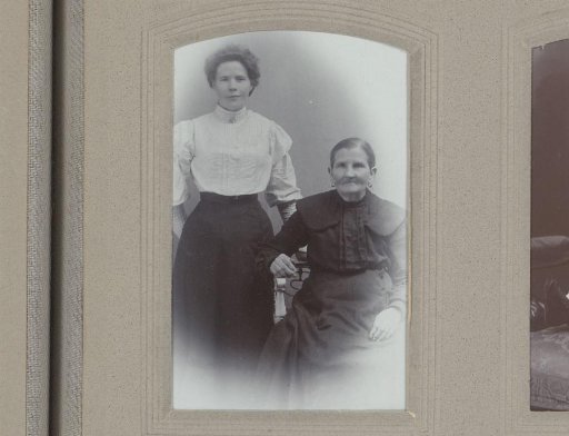 Portrait of a standing woman and a seated elderly woman