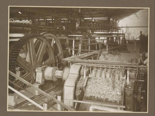 Machinery and workers in a hall of the Boedoeran sugar factory in Sidoarjo, Java