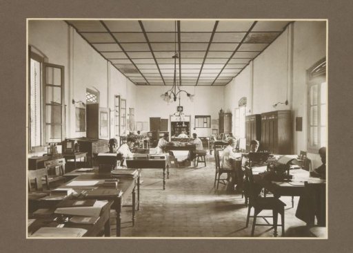 Office interior with clerks and furniture of the Goedo sugar factory in Djombang, Java