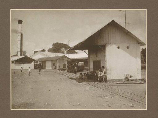 People at the weighbridge and locomotive shed of the Meritjan sugar factory in Kediri, Java