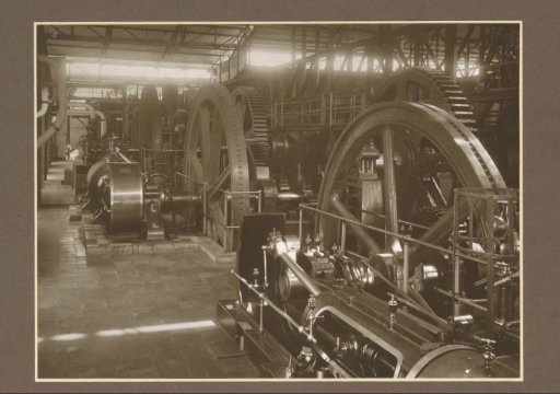 Machines and workers in the hall of the Ngandjoek sugar factory on Java