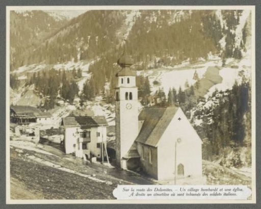 Bombarded village with a church and a cemetery in the Dolomites