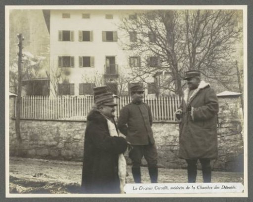 Doctor Cervelli (right) in conversation with soldiers, presumably Italians