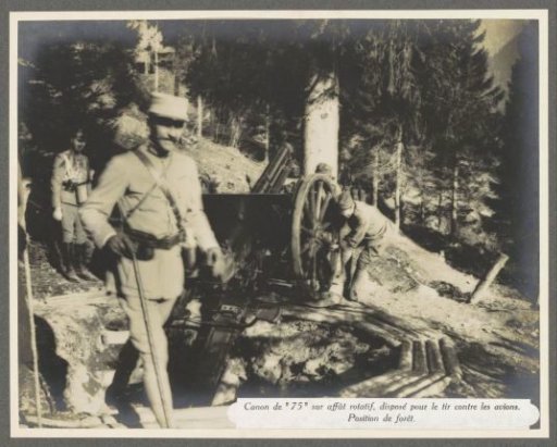 Soldiers at a 75 mm anti-aircraft gun on a rotating mount in the forests of the Dolomites, presumably Italian