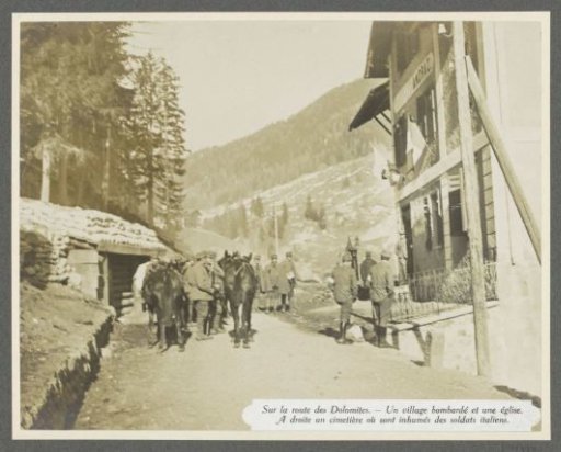 Soldiers on the street in the bombarded village of Andraz