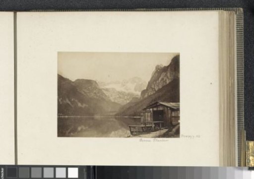 View of the Gosaugletscher with a mountain lake and a hut in the foreground