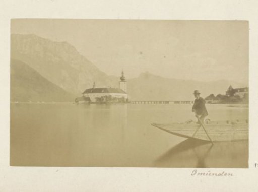 View of Schloss Ort in the Traunsee near Gmunden with a man in a rowing boat in the foreground