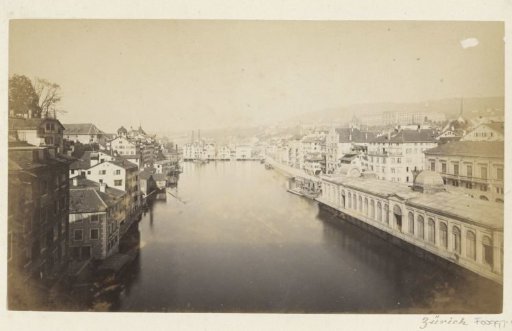 View of a river and buildings in Zürich, in the foreground to the right the Fleischhalle