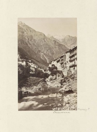 Mountain village of Chiavenna seen from a stream