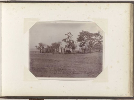 View of a destroyed house with a man and women in front of it in South Africa