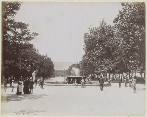 Square with a fountain and strolling people in Naples