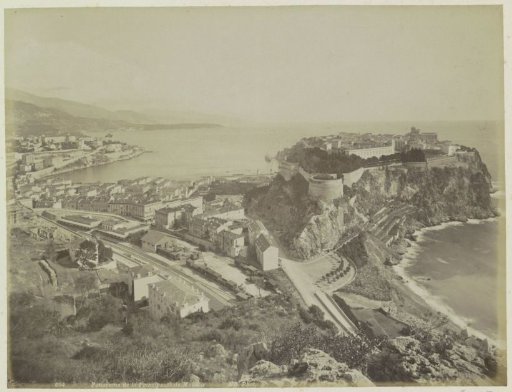 View of Monaco with the old fortified town on the right and a railway station in the foreground