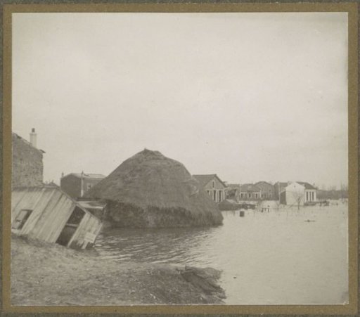 Collapsed haystack and destroyed barn in a flooded suburb of Paris