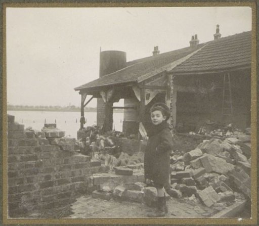 Child near a destroyed building in a flooded suburb of Paris