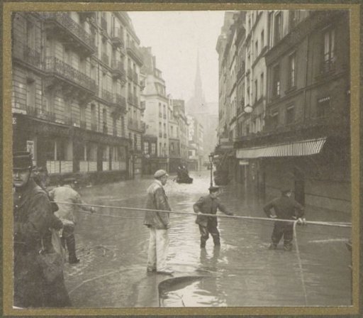 Men carrying out a rescue operation on the street during the Paris flood