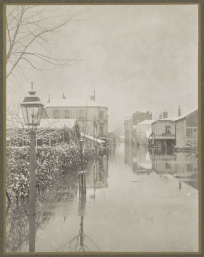 Flooded street with snow-covered houses in a suburb of Paris