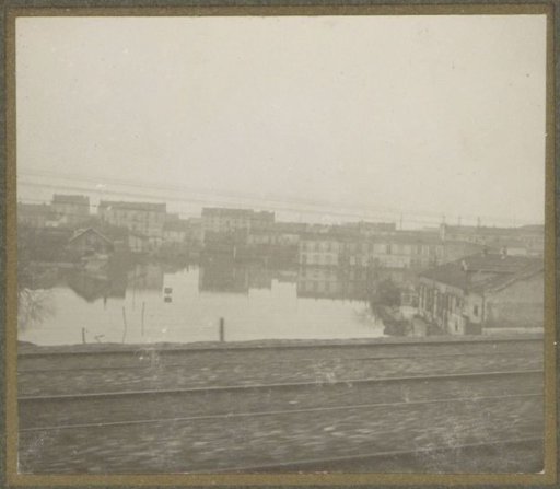 Flooded buildings during the Paris flood, viewed from a train